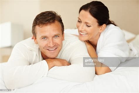 Happy Mature Couple Lying On Bed High Res Stock Photo Getty Images