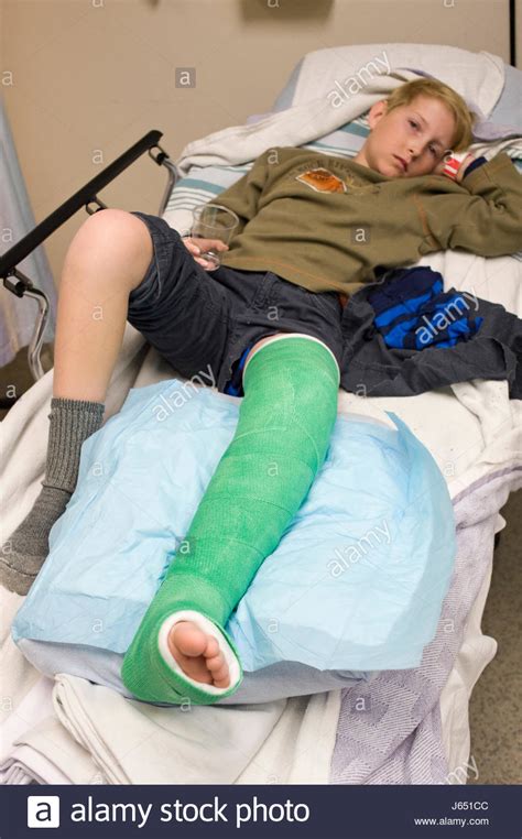 Eleven Year Old Boy With A Broken Leg Lying On Hospital Bed With A