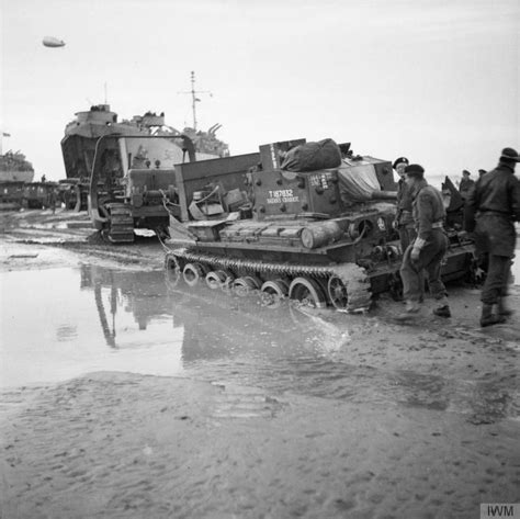 A Bulldozer Being Used To Removed A British Cromwell Tank Stuck On The