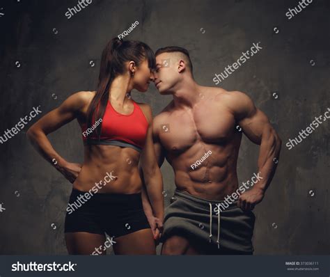 Fitness Couple Shirtless Bodybuilder And Fitness Woman Kissing Each