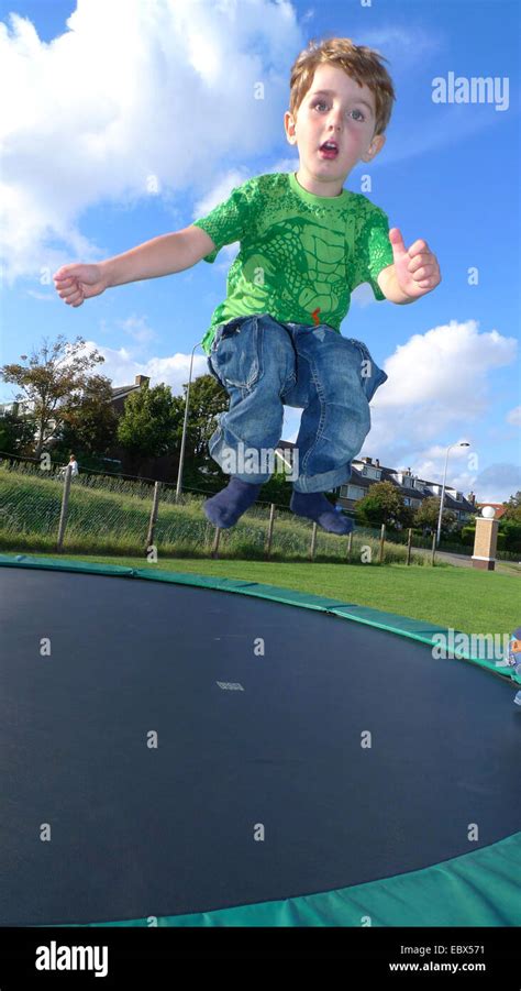 Little Boy Jumping On A Trampoline Stock Photo Alamy