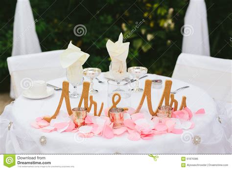 Whether you're organizing the party as part of a large group or coordinating the details yourself, the decor of the event space will set the mood for the entire bridal. Bride And Groom Wedding Reception Table Decor. Stock Photo ...