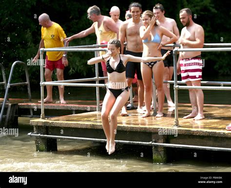 People Sunbathing At The Mixed Bathing Pond On Hampstead Heath London As Heatwave Conditions