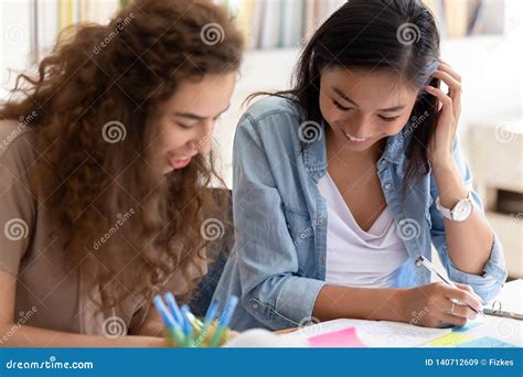 Two Happy Diverse Girls College Friends Studying Together In Campus
