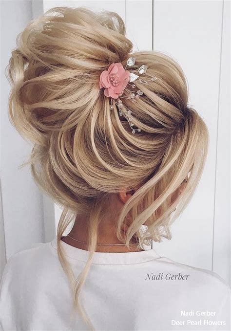 The way the hair has been wrapped up high in a large and voluminous style would go perfectly with an overall grecian themed wedding, while the strands of hair coming from the front and going below the main part of the updo make this one of my favorite subtle touches in any of these wedding updos. Top 20 High Bun Wedding Updo Hairstyles | Deer Pearl Flowers