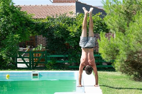 Premium Photo Person Doing A Handstand By The Pool 2