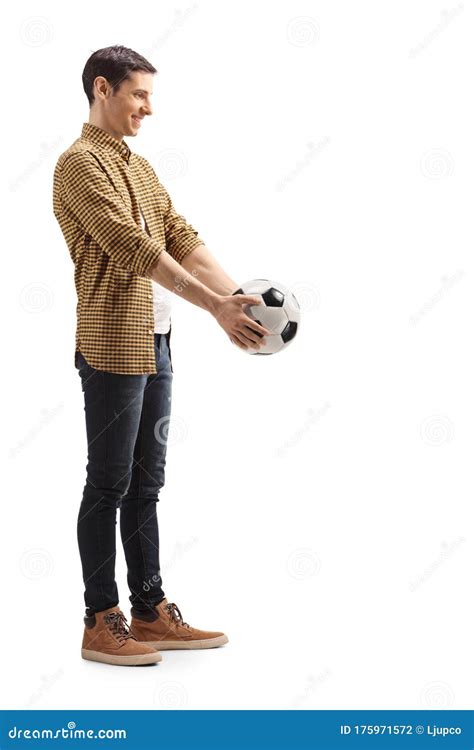 Casual Young Man Holding A Soccer Ball And Smiling Stock Photo Image