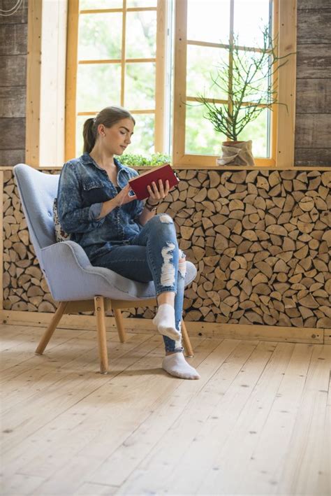 Free Photo Stylish Woman Sitting On Chair And Reading Book Sitting