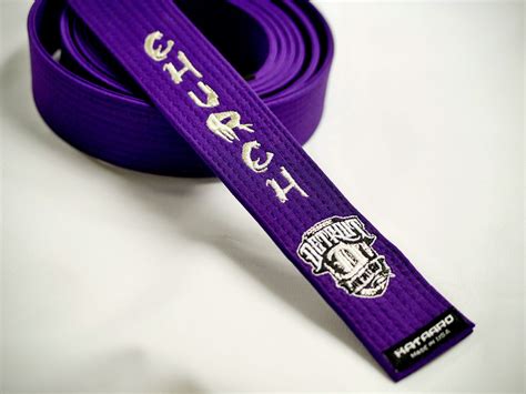 A Purple Belt With The Word Rchc On It Is Laying On A White Surface