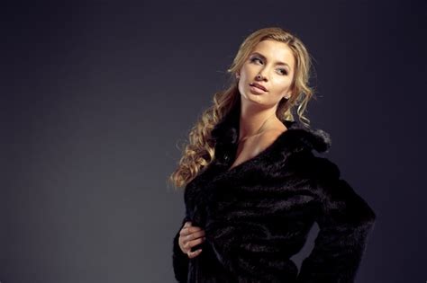 premium photo fashion seductive blond hair lady in an elegant fur coat and black underwear