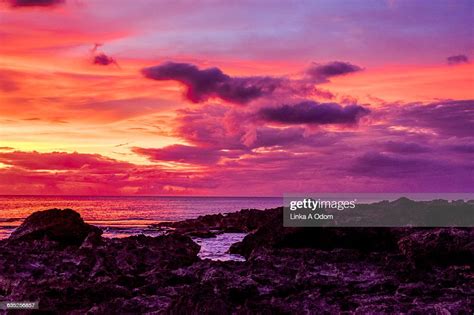 Dark Red Sunset Over Ocean Rocks Stock Photo Getty Images