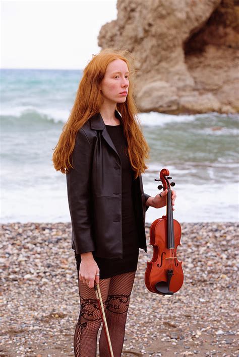 Young Redhead Female Violinist With Her Violin On The Beach A Cl