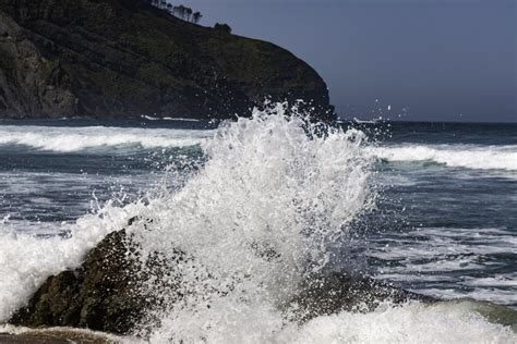 Water Splashing On The Rocks On The Coast Of The Sea Stock Photo