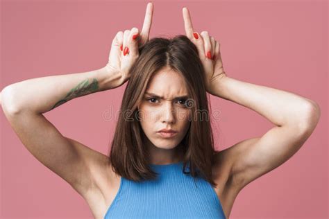 Image Of Angry Brunette Woman Holding Fingers On Her Head Like Devil Horns Stock Photo Image