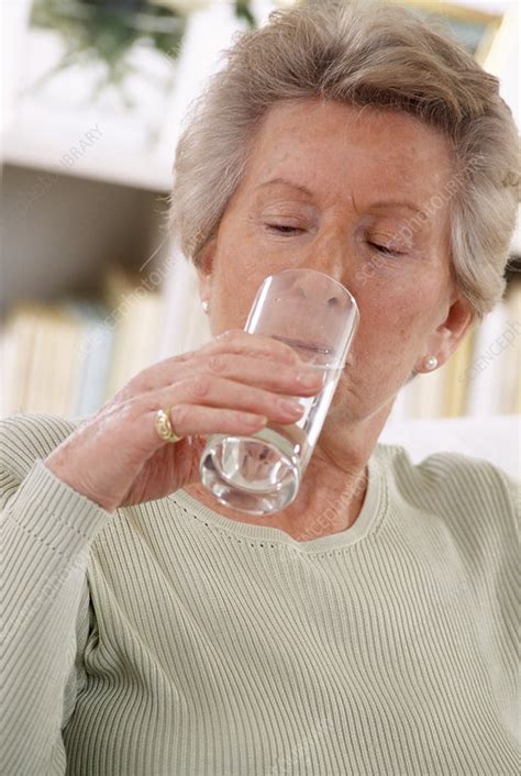 What to buy for elderly woman. Elderly woman drinking water - Stock Image - P920/0210 ...