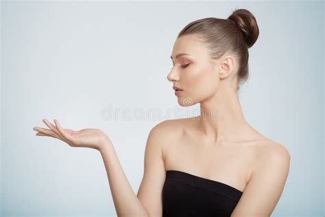 Woman Holds Out Her Hand Clean Skin Concept Blue Background Stock