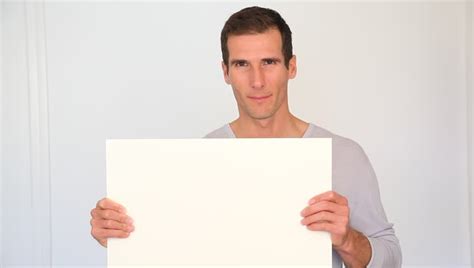 Mid Shot Of Black Man Raising And Holding A White Board Smiling