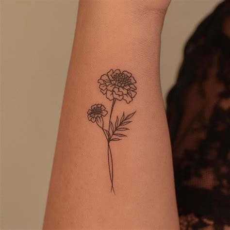 Marigold Tattoo Located On The Wrist Fine Line Style