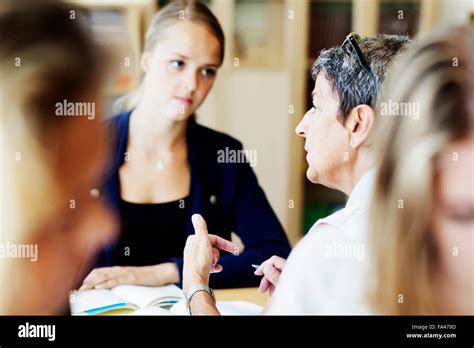 Female Teacher Explaining To Student In Classroom Stock Photo Alamy