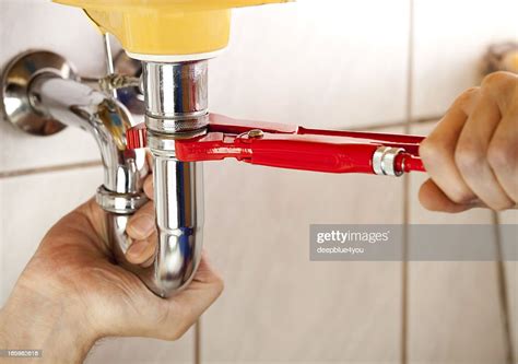 Plumber Fixing A Sink In Bathroom High Res Stock Photo Getty Images
