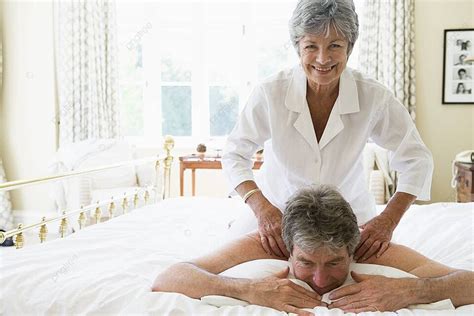 woman giving man massage in bedroom smiling couple lifestyle relaxed photo background and