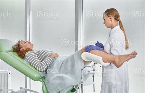 Doctor Preparing For Gynecological Examination Of Mature Woman Stock