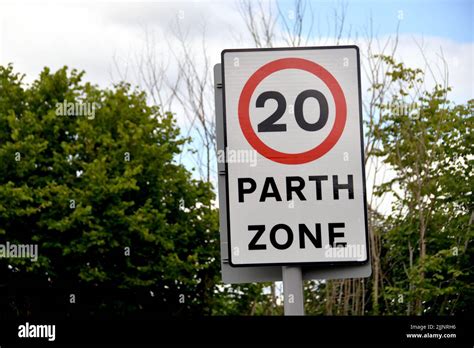 Bilingual Road Sign Showing A 20 Mph Speed Limit At The Approach To A