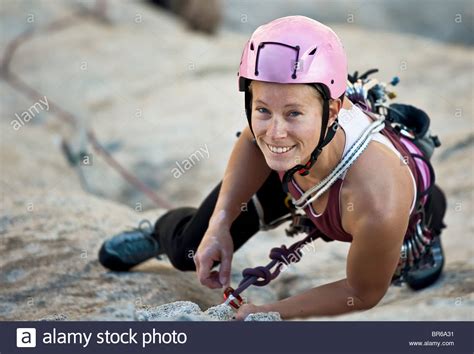 Female Rock Climber Is Focused On Her Next Move As She Battles Her Way