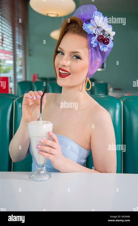 1960s Look Pin Up Girl In An American Diner With A Milkshake Stock