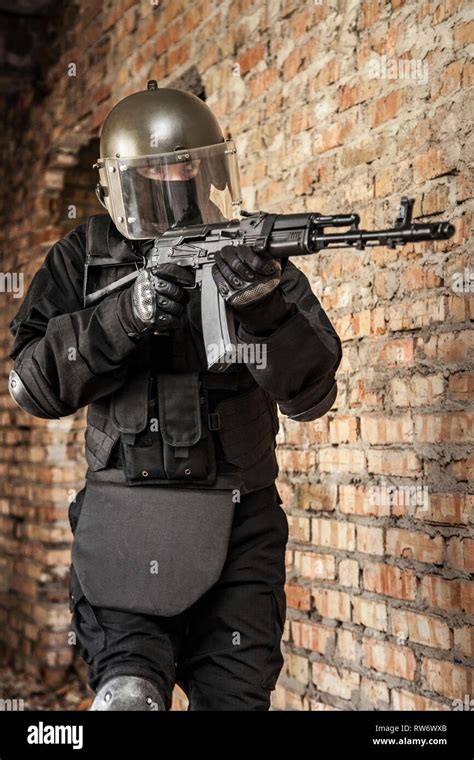 Special Forces Operator In Black Uniform And Bulletproof Vest Stock