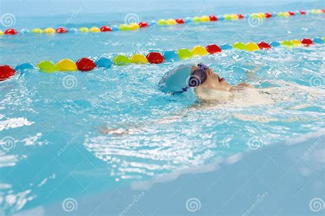 Little Boy Swimming In Pool Kid In Glass Learning Swim By Crawls