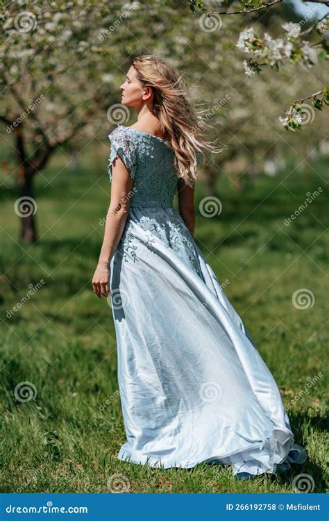 Portrait Of A Blonde In The Park Beautiful Woman With Long Blond Hair In A Blue Dress Stock