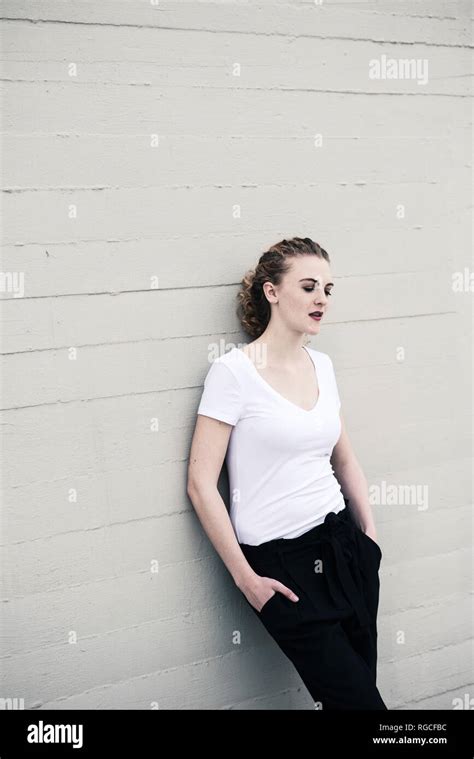 Portrait Of Cool Young Woman Leaning Against Wall Stock Photo Alamy