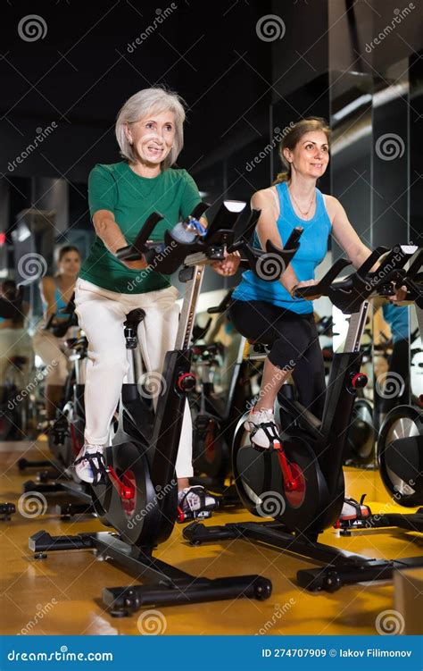 Two Mature Woman Training On Fitness Bikes Stock Image Image Of Fitness Training