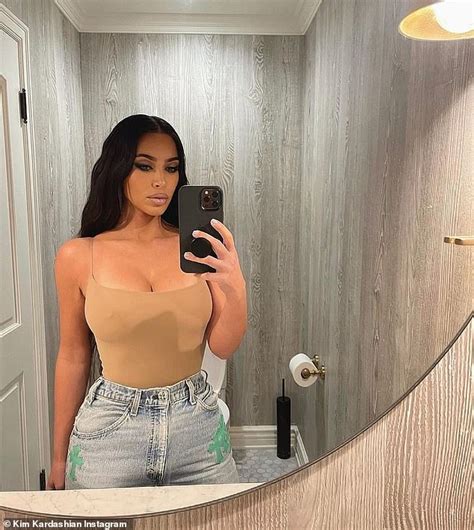kim kardashian goes braless as she puts her famous curves on display in nude tank top daily