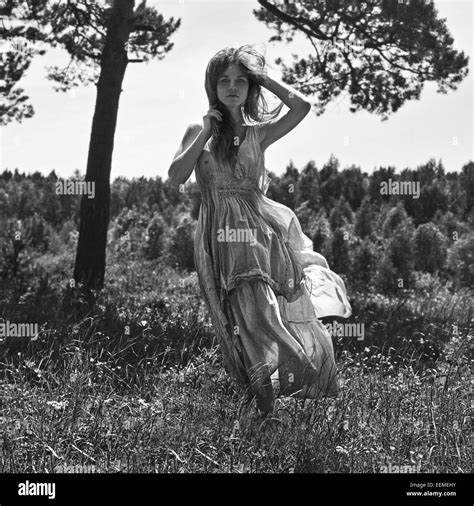 Caucasian Woman Walking In Rural Field Stock Photo Alamy