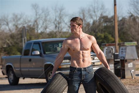 Shirtless Hunk Carrying Tires At A Gas Station Rob Lang Images