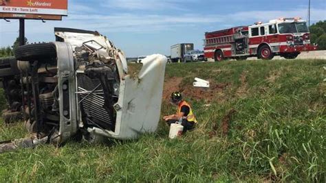 Tractor Trailer Truck Overturns Injuring Driver Causing Fuel Leak