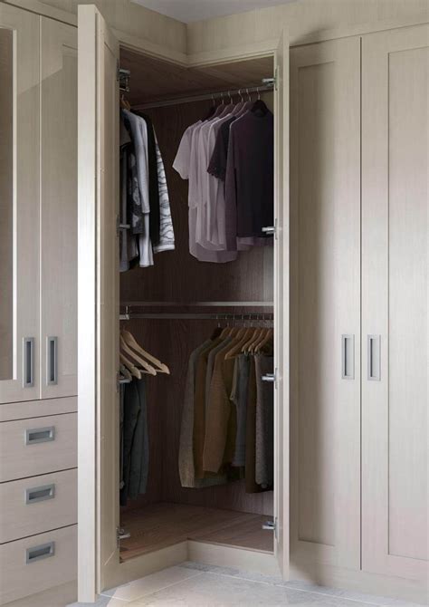 An Open Closet With Clothes Hanging On Hangers