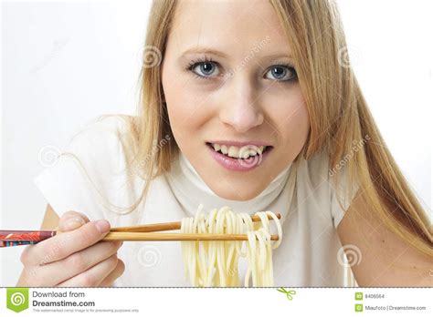 Plastic chopsticks in right hand, soup spoon in left. Blond Woman Use Chopsticks Eating Noodles Stock Photo - Image of food, blond: 8406564