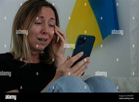 Young Anxious Woman With Cried Out Eyes Reading The News About Ukraine