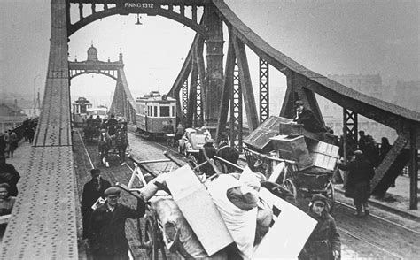 jews who are being forced to relocate to the krakow ghetto move their belongings in carts and