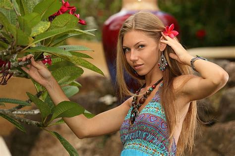 anjelica ebbi jewelry blue pattern dress blonde red flower in her hair sitting hd