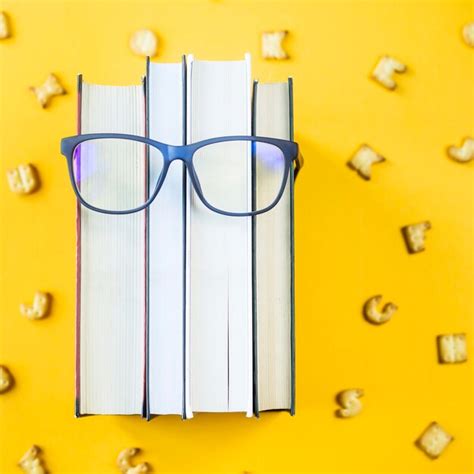 Premium Photo A Stack Of Books With Glasses Is An Image Of A Persons Face