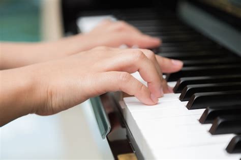 Free Photo Close Up Of Hands Playing Piano