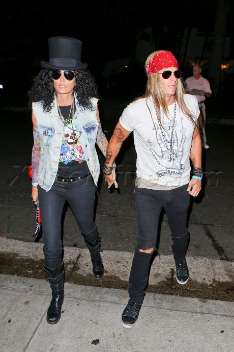 Axl rose with a plaid shirt wrapped around his waist: Cindy Crawford And Hubby Dress Up As Slash And Axl Rose ...
