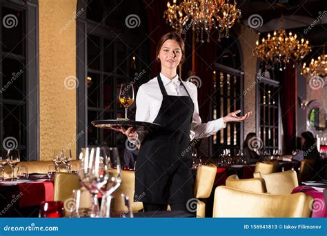 Waiter Standing With Serving Tray Recommending Dishes In Restaurant