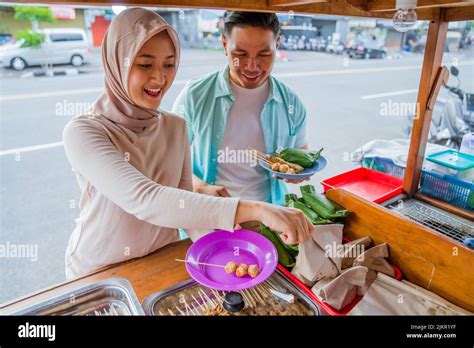 Couple Picking Some Snack And Food At Traditional Street Food Stall