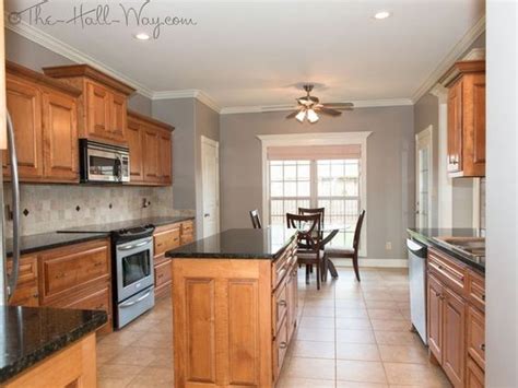 Look for greens, greys, and browns to make the red pop. Neutral Grey Walls (Medium) and Warm Honey Cabinets ...