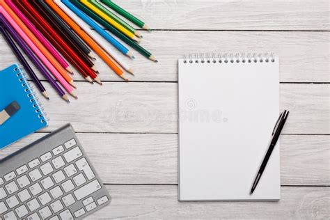 White Notebook And Color Pencils On A White Table Stock Photo Image